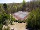 Aerial view of community tennis court, pool, playground, and parking for residents and guests at 3641 Willow Club Dr, Loganville, GA 30052