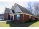 Brick home with green shutters and manicured front lawn and landscaping at 3641 Willow Club Dr, Loganville, GA 30052