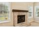 Close up of fireplace with brick surround and dark wooden mantle at 3641 Willow Club Dr, Loganville, GA 30052