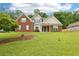 Charming two-story home featuring a well-manicured lawn and a mix of brick and siding accents at 3641 Willow Club Dr, Loganville, GA 30052