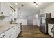 Bright kitchen features granite countertops, stainless steel refrigerator, and white cabinets at 3641 Willow Club Dr, Loganville, GA 30052