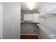 A laundry room featuring white cabinets, shelving, and wood flooring, ideal for efficient organization and storage at 3641 Willow Club Dr, Loganville, GA 30052