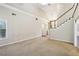 Spacious living room with large windows, a staircase, and bright neutral paint at 3641 Willow Club Dr, Loganville, GA 30052