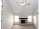 Open-concept living room featuring a brick fireplace, carpeted floors, and abundant natural light at 3641 Willow Club Dr, Loganville, GA 30052