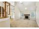 Open-concept living area with a fireplace, vaulted ceilings, and staircase at 3641 Willow Club Dr, Loganville, GA 30052