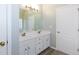 Main bathroom featuring a double sink vanity with white cabinets and a large framed mirror at 3641 Willow Club Dr, Loganville, GA 30052