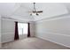 A spacious main bedroom with a tray ceiling, carpeted floors, and large window for ample natural light at 3641 Willow Club Dr, Loganville, GA 30052