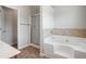 Large soaking tub with tile accents and separate glass shower at 5152 Rapahoe Trl, Atlanta, GA 30349