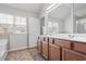 Bathroom with double sink vanity, tub, and bright windows at 5152 Rapahoe Trl, Atlanta, GA 30349