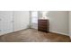 Carpeted bedroom featuring a closet, window, and chest of drawers at 5152 Rapahoe Trl, Atlanta, GA 30349