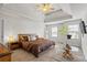 Spacious main bedroom features a tray ceiling, ceiling fan, and plenty of natural light at 5152 Rapahoe Trl, Atlanta, GA 30349