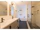 Modern bathroom featuring double vanity, soaking tub, and glass-enclosed shower with dark hexagon tiles and matte fixtures at 1744 Millview Dr, Marietta, GA 30062