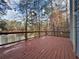 Wooden deck overlooking a serene lake surrounded by trees, creating a relaxing outdoor space at 1744 Millview Dr, Marietta, GA 30062