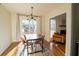 Open dining room with a modern light fixture and sliding doors to the outside with a view into the living room at 1744 Millview Dr, Marietta, GA 30062