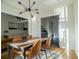 Sunlit dining room features a modern chandelier, a wood table with seating for four, and an area rug at 1744 Millview Dr, Marietta, GA 30062
