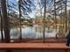 Scenic view of the community lake with a fountain as seen from a wooded backyard at 1744 Millview Dr, Marietta, GA 30062