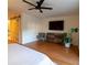 Well-lit bedroom with hardwood floors, a sliding barn door, a ceiling fan, and modern furnishings at 1744 Millview Dr, Marietta, GA 30062