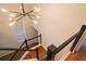Modern staircase featuring wood steps and minimalist railing, illuminated by stylish lighting at 1744 Millview Dr, Marietta, GA 30062