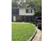 Two-story townhome with a green lawn and a truck parked in the driveway at 1871 Se Whitehall Se Ct, Atlanta, GA 30316