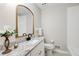 Bathroom featuring a granite countertop, a mirror, and a toilet at 2270 Old Concord Se Dr, Covington, GA 30016
