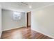 Bedroom with wood floors, light gray walls, window and an open doorway at 2270 Old Concord Se Dr, Covington, GA 30016