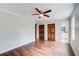 Bedroom featuring hardwood floors, ceiling fan, and access to bathroom at 2270 Old Concord Se Dr, Covington, GA 30016