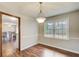 Bright dining room with hardwood floors, a classic chandelier, and natural light from the window at 2270 Old Concord Se Dr, Covington, GA 30016