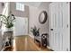 Bright foyer with high ceilings, hardwood floors, plants, decorative mirror, and a white front door at 1241 Skylar Ridge Cir, Buford, GA 30519