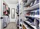 Organized walk-in closet with shelves for shoes and hanging space for clothes at 1241 Skylar Ridge Cir, Buford, GA 30519