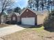 One-story home with brick accents, an attached two-car garage, and a concrete driveway at 396 Avian Forest Dr, Stockbridge, GA 30281