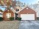 Charming single-Gathering home featuring a brick facade, attached two-car garage, and well-maintained front lawn at 396 Avian Forest Dr, Stockbridge, GA 30281