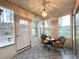 Cozy sunroom with patterned tile, wicker furniture, and lots of natural light at 396 Avian Forest Dr, Stockbridge, GA 30281