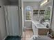 Bright bathroom featuring double sink vanity, arched window, and a shower/tub combo at 4804 Mceachern Way, Powder Springs, GA 30127