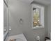 Bright bathroom with a window, neutral color palette, and modern fixtures at 4804 Mceachern Way, Powder Springs, GA 30127