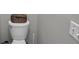 Close-up shot of a toilet, light switch, and a basket on top of the toilet lid at 4804 Mceachern Way, Powder Springs, GA 30127