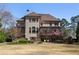 Expansive backyard view highlighting the multi-level patio and deck of the brick two-story home at 9070 Waits Ferry Xing, Johns Creek, GA 30097