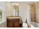 Bathroom featuring granite countertop, tiled shower and tub, and window at 9070 Waits Ferry Xing, Johns Creek, GA 30097