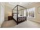 Bedroom with neutral carpet, a four poster bed, and a window with natural light at 9070 Waits Ferry Xing, Johns Creek, GA 30097