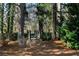 Charming wooded pathway featuring a rustic wooden bridge amidst mature trees at 9070 Waits Ferry Xing, Johns Creek, GA 30097