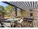 Outdoor deck featuring shaded pergola, ample seating, and views of the wooded backyard at 9070 Waits Ferry Xing, Johns Creek, GA 30097