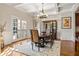 Refined dining room with coffered ceiling, hardwood floors, French doors, and stylish chandelier at 9070 Waits Ferry Xing, Johns Creek, GA 30097