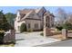 Elegant brick home with manicured landscaping and a welcoming driveway creates impressive curb appeal at 9070 Waits Ferry Xing, Johns Creek, GA 30097