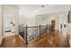 Hallway with decorative iron railing leading to bedrooms and other living spaces at 9070 Waits Ferry Xing, Johns Creek, GA 30097