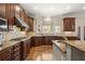 Well-equipped kitchen featuring wood cabinets, granite countertops, and tile backsplash at 9070 Waits Ferry Xing, Johns Creek, GA 30097