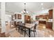 Open-concept kitchen and dining area with wood cabinets and view to the staircase at 9070 Waits Ferry Xing, Johns Creek, GA 30097