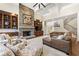 Bright living room featuring a stone fireplace, wood cabinets, and a staircase at 9070 Waits Ferry Xing, Johns Creek, GA 30097