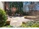 Stone patio featuring dining area, gas grill, and a built in stone fire pit at 9070 Waits Ferry Xing, Johns Creek, GA 30097