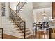 Staircase with decorative iron railing and hardwood steps overlooking dining and living areas at 9070 Waits Ferry Xing, Johns Creek, GA 30097