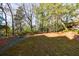 Spacious backyard with mature trees and natural landscaping creating a serene outdoor environment at 2650 Peachtree Battle Nw Pl, Atlanta, GA 30327