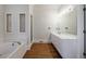 Bathroom featuring a soaking tub, shower, and vanity at 2650 Peachtree Battle Nw Pl, Atlanta, GA 30327